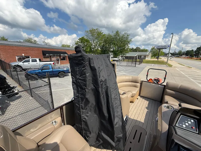 Slide: The Image of 2023 Veranda VTX 22RC pontoon boat with covered console, parked near a dealership. - 49