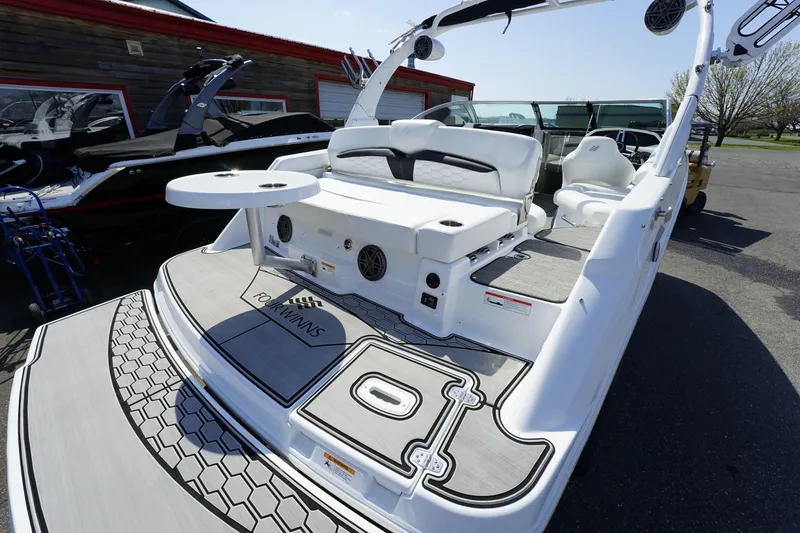 Slide: The Image of 2023 Four Winns HD3 Surf boat with sleek deck design and modern seating. - 10