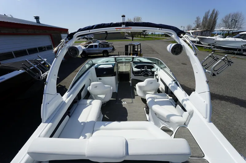 Slide: The Image of 2023 Four Winns HD3 Surf boat interior with white seating and modern dashboard. - 11