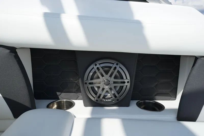Slide: The Image of 2023 Four Winns HD3 Surf boat interior with speaker and cup holders. - 14
