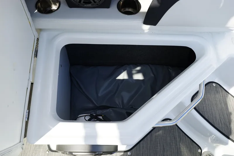 Slide: The Image of 2023 Four Winns HD3 Surf boat storage compartment with cup holders and speaker. - 15