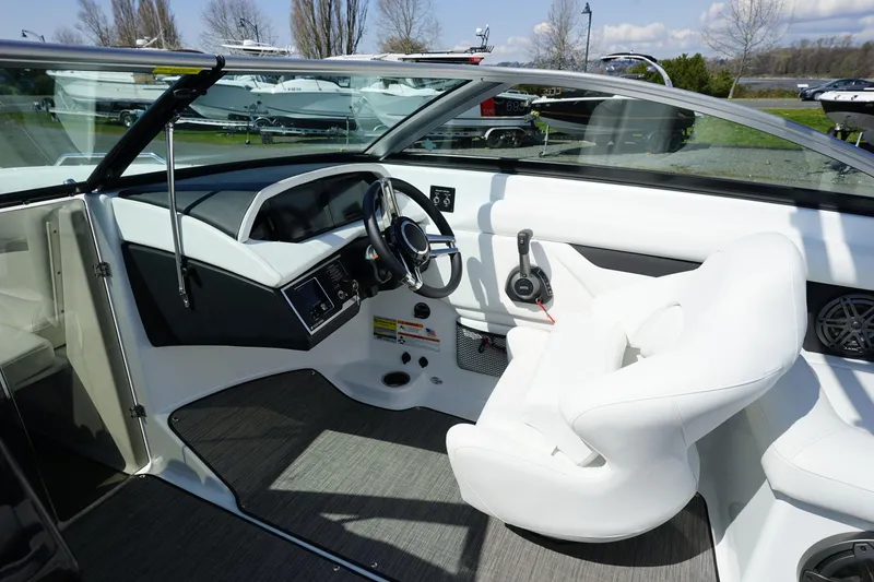 Slide: The Image of 2023 Four Winns HD3 Surf boat interior with sleek white seating and modern dashboard. - 17