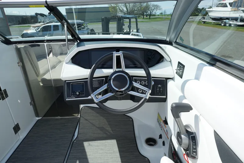 Slide: The Image of 2023 Four Winns HD3 Surf boat cockpit with modern steering and controls. - 18