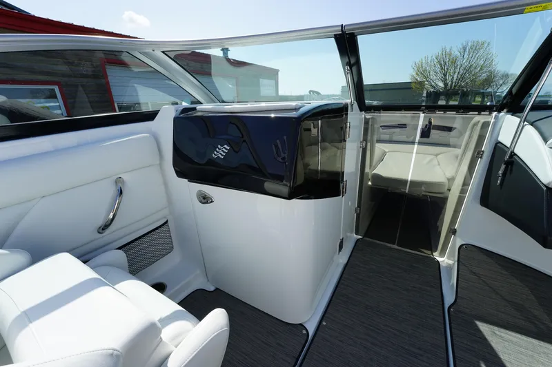 Slide: The Image of 2023 Four Winns HD3 Surf boat interior with sleek white seating and modern dashboard. - 19