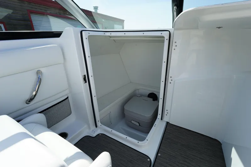 Slide: The Image of 2023 Four Winns HD3 Surf boat interior with compact storage compartment. - 20