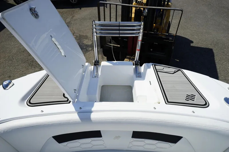 Slide: The Image of 2023 Four Winns HD3 Surf boat with open storage compartment and sleek design. - 26