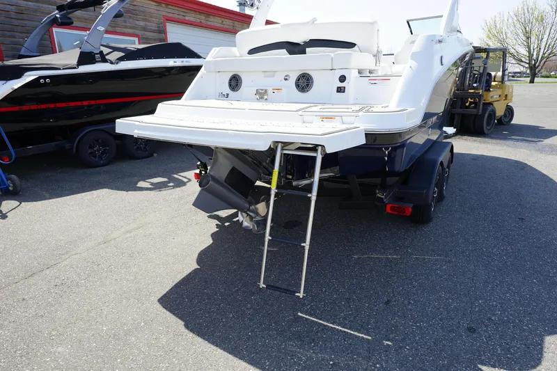 Slide: The Image of 2023 Four Winns HD3 Surf boat, rear view with swim platform and ladder. - 6