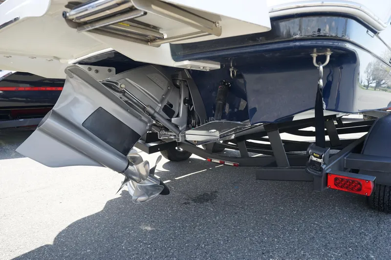 Slide: The Image of 2023 Four Winns HD3 Surf boat's stern and propeller on a trailer. - 7