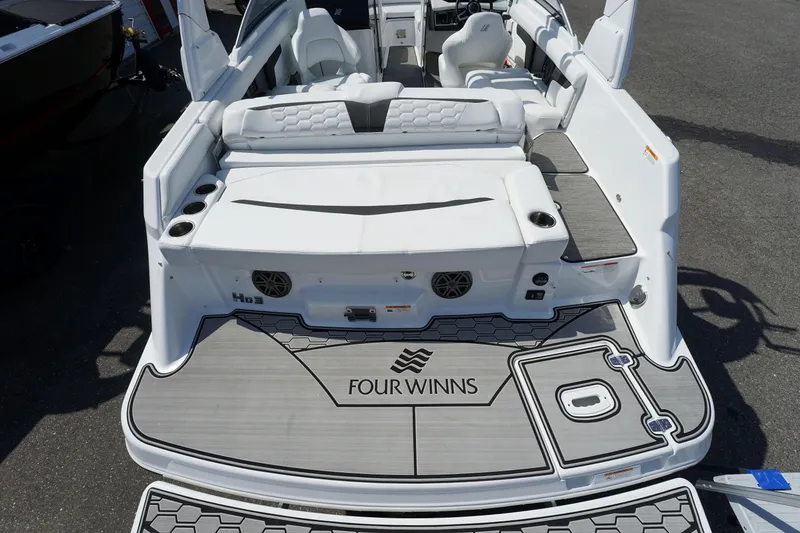 Slide: The Image of 2023 Four Winns HD3 Surf boat with spacious seating and modern design. - 8