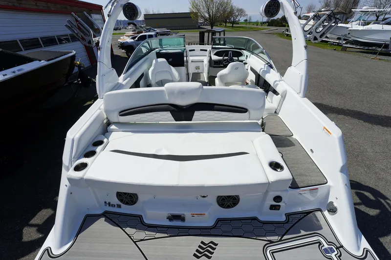Slide: The Image of 2023 Four Winns HD3 Surf boat interior with white seating and modern design. - 9