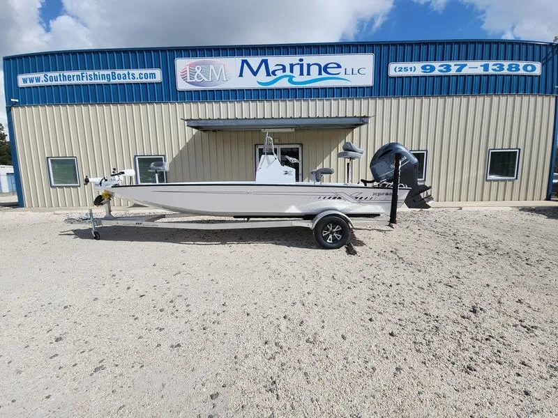 Slide: The Image of 2025 Xpress H210 BAY boat parked outside L&M Marine LLC building. - 0