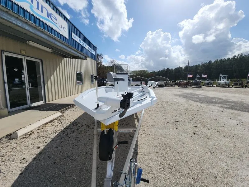 Slide: The Image of 2025 Xpress H210 BAY boat displayed outside a dealership under a partly cloudy sky. - 10