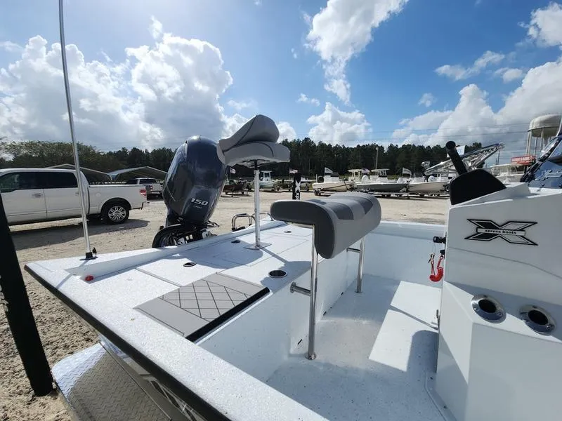 Slide: The Image of 2025 Xpress H210 BAY boat with Yamaha engine, parked outdoors under a cloudy sky. - 11