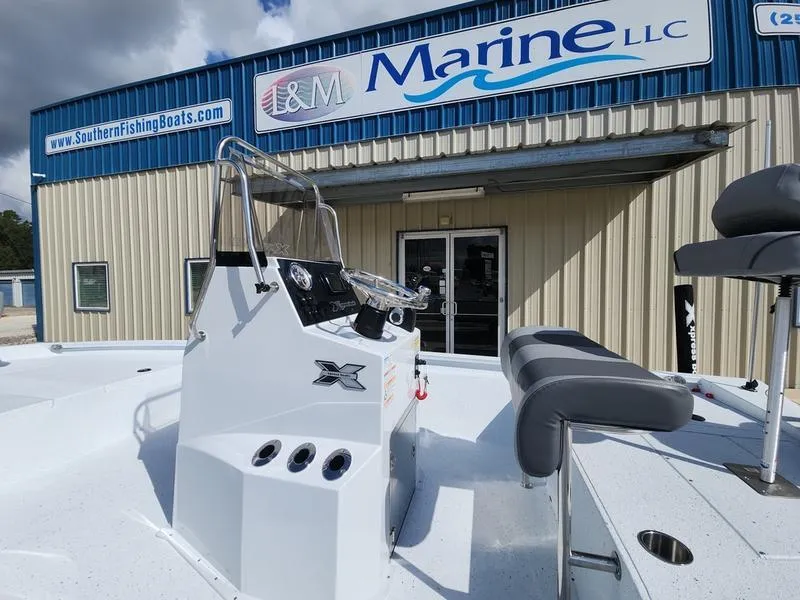 Slide: The Image of 2025 Xpress H210 BAY boat at I&M Marine dealership entrance. - 13