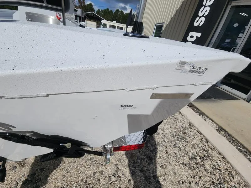 Slide: The Image of 2025 Xpress H210 BAY boat front view, white hull, parked outdoors. - 15