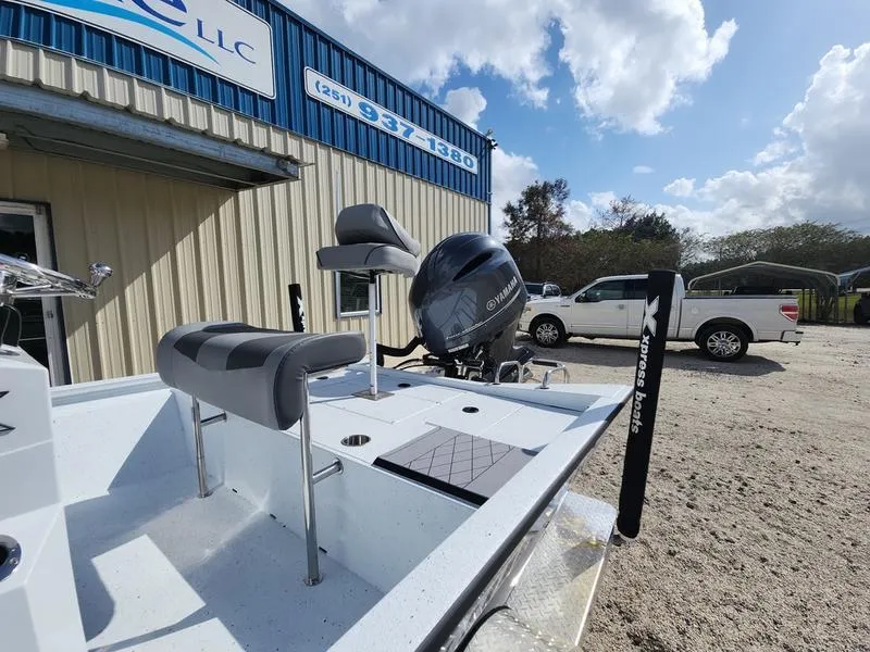 Slide: The Image of 2025 Xpress H210 BAY boat with Yamaha engine, parked outside a dealership under a cloudy sky. - 4