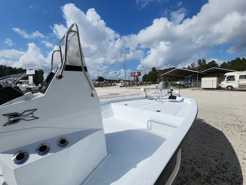 Slide: The Image of 2025 Xpress H210 BAY boat under a bright blue sky with scattered clouds. - 8