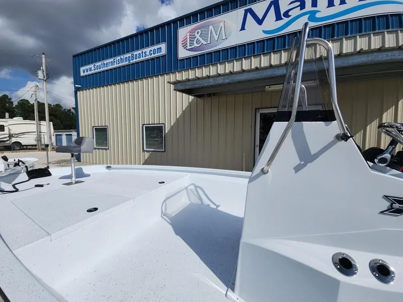Slide: The Image of 2025 Xpress H210 BAY boat at L&M Marine dealership under cloudy sky. - 9