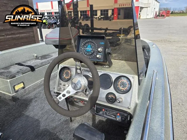 Slide: The Image of 1984 Champion CHAMP 2 boat dashboard with steering wheel and gauges at Sunrise Marine. - 7