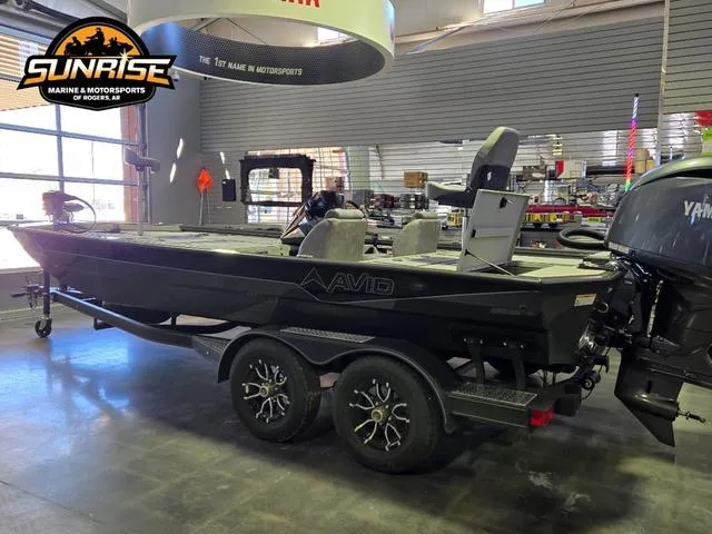 Slide: The Image of Avid 20 Vertex 2025 boat in showroom, featuring dual-axle trailer and Yamaha outboard motor. - 16