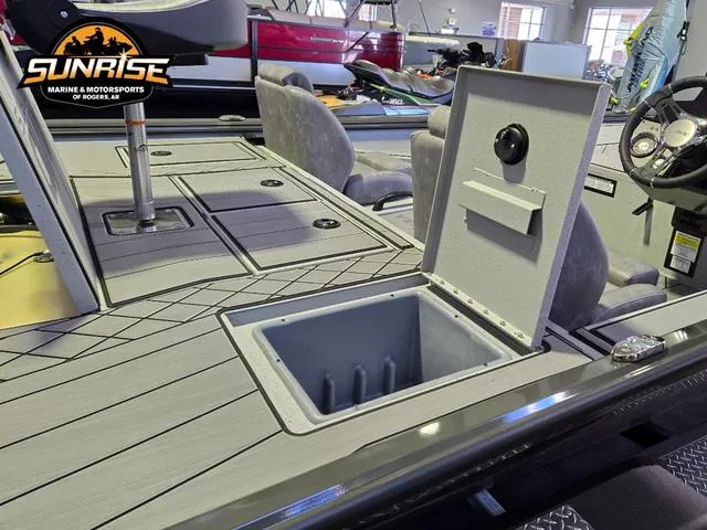 Slide: The Image of 2025 Avid 20 Vertex boat interior with open storage compartment, gray seating, and steering wheel. - 22