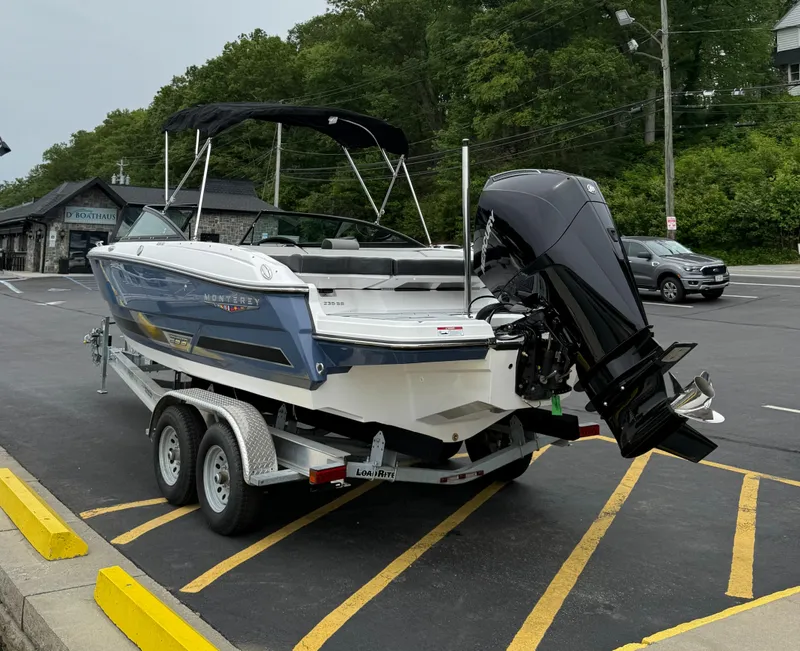 Slide: The Image of 2025 Monterey 235 Super Sport boat on trailer in parking lot. - 3