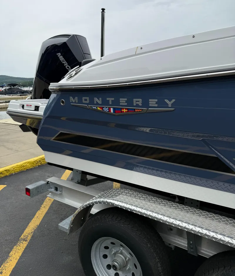 Slide: The Image of 2025 Monterey 235 Super Sport boat on trailer, showcasing sleek design and branding. - 4