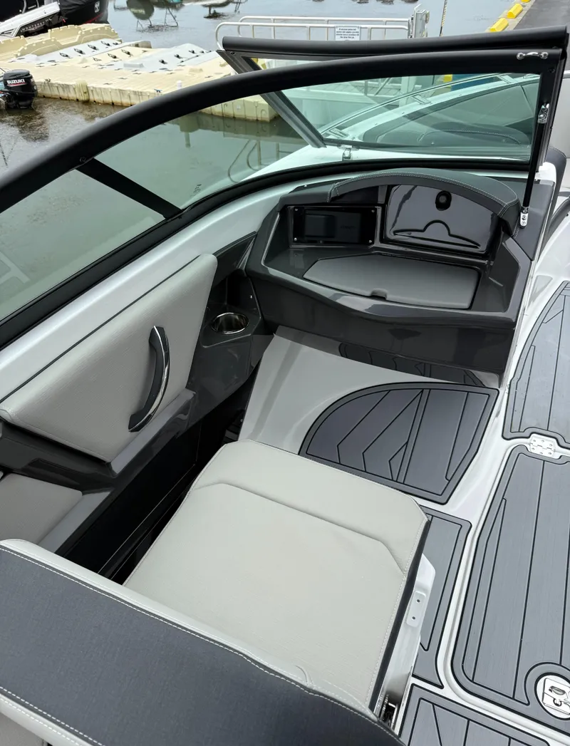 Slide: The Image of 2025 Monterey 235 Super Sport boat interior with sleek seating and modern dashboard design. - 8