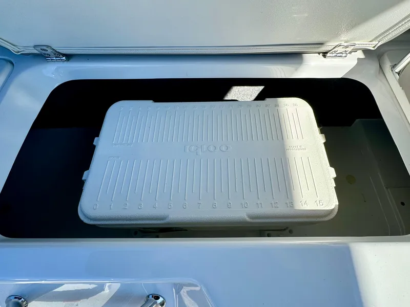 Slide: The Image of 2023 Four Winns H2 boat storage compartment with Igloo cooler inside. - 13