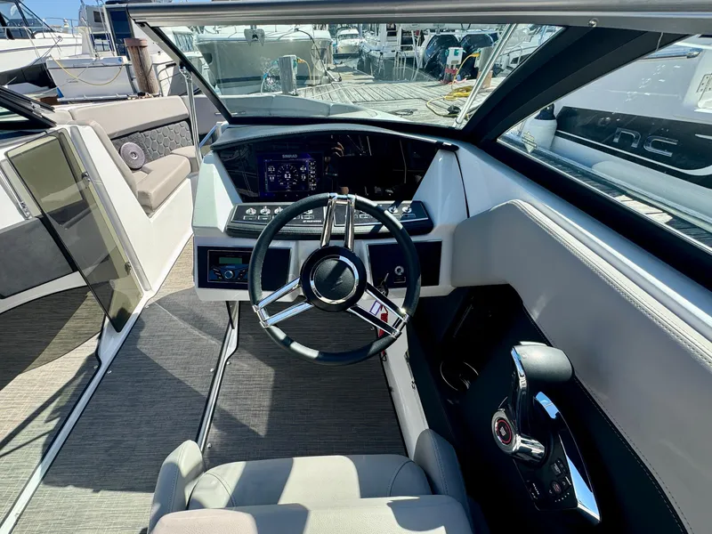 Slide: The Image of 2023 Four Winns H2 boat cockpit with modern steering and dashboard controls. - 16
