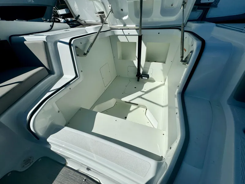 Slide: The Image of 2023 Four Winns H2 boat storage compartment with open hatch, showcasing spacious interior design. - 9