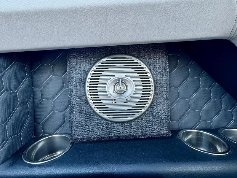 Slide: The Image of 2023 Four Winns H2 interior speaker with hexagonal pattern and cup holders. - 12