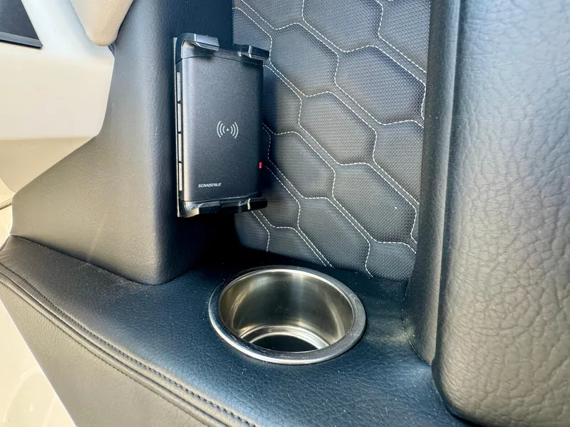 Slide: The Image of Interior of 2023 Four Winns H2 boat with cup holder and wireless charger. - 15