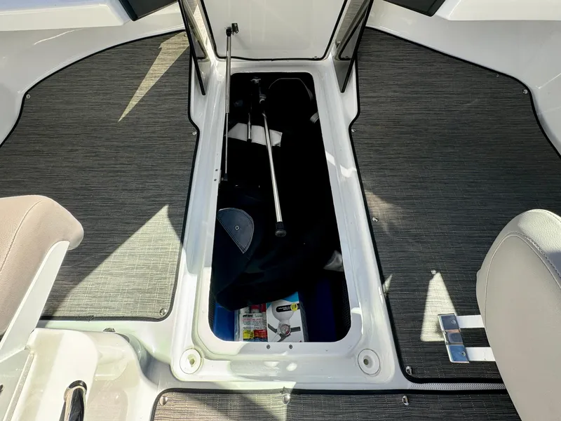 Slide: The Image of 2023 Four Winns H2 boat interior storage compartment with equipment and accessories. - 17