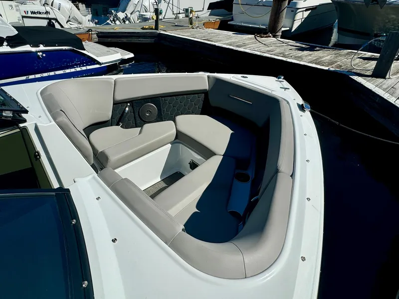 Slide: The Image of 2023 Four Winns H2 boat with spacious seating at a marina. - 18