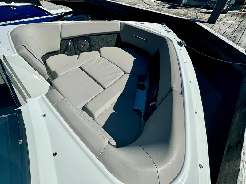 Slide: The Image of 2023 Four Winns H2 boat interior with gray seating and cup holders. - 20