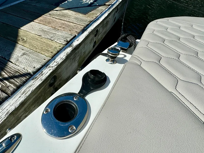 Slide: The Image of 2023 Four Winns H2 boat detail with dock, featuring sleek seating and hardware. - 21