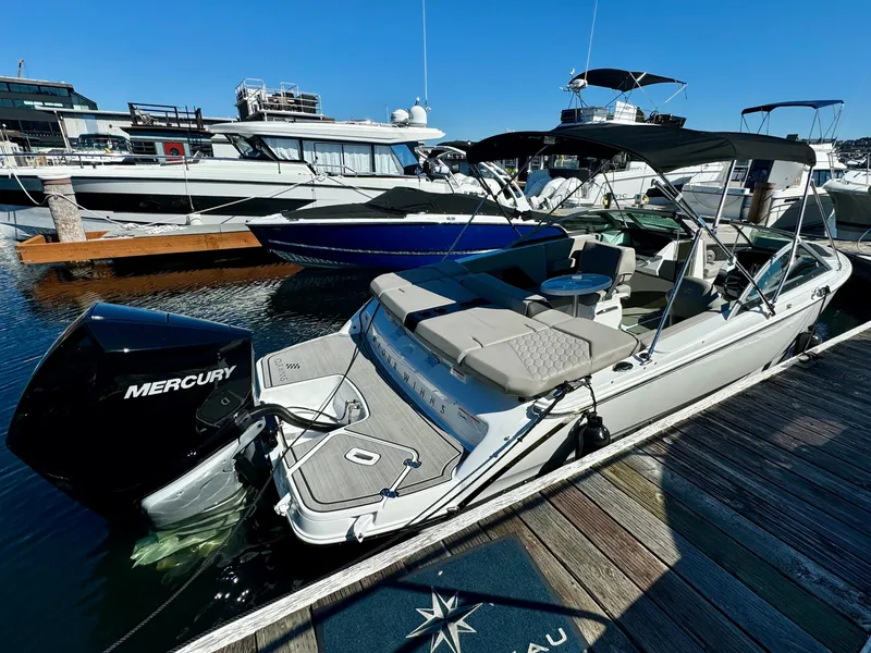 Slide: The Image of 2023 Four Winns H2 boat docked, featuring a Mercury outboard motor and spacious seating. - 5