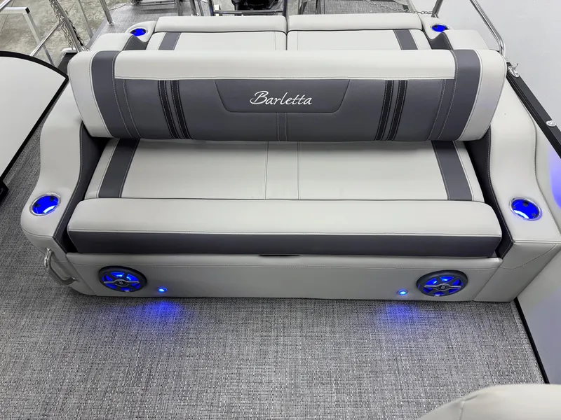 Slide: The Image of 2025 Barletta Corsa 23UC boat seating with integrated cup holders and blue LED lighting. - 10