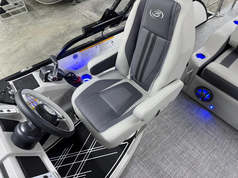 Slide: The Image of 2025 Barletta Corsa 23UC boat interior with captain's chair and steering wheel. - 13