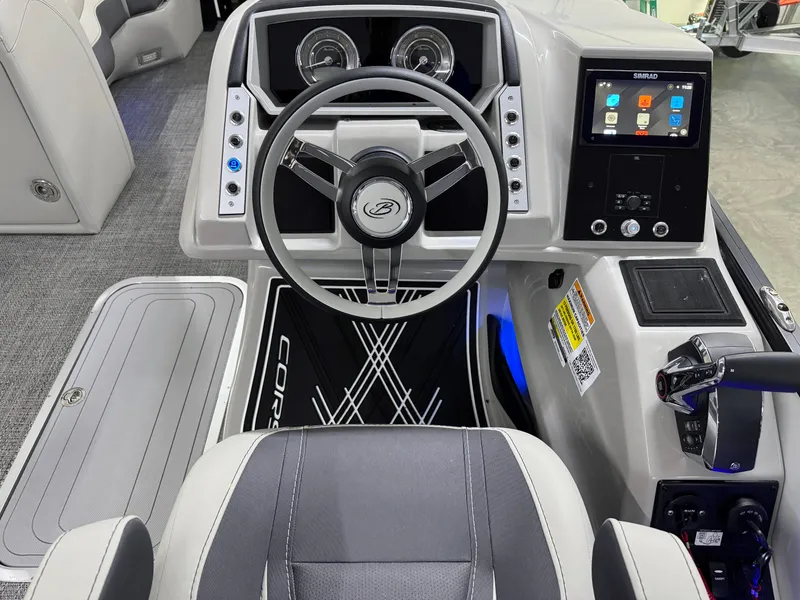 Slide: The Image of 2025 Barletta Corsa 23UC boat dashboard with steering wheel and digital display. - 15