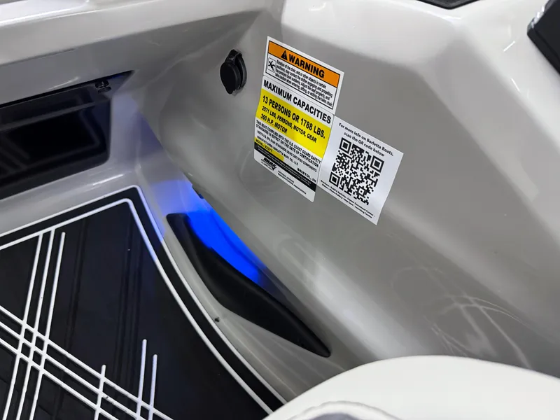 Slide: The Image of 2025 Barletta Corsa 23UC interior with capacity warning label and blue LED lighting. - 16