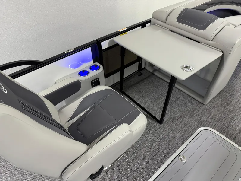 Slide: The Image of 2025 Barletta Corsa 23UC interior with seating, table, and illuminated cup holders. - 21