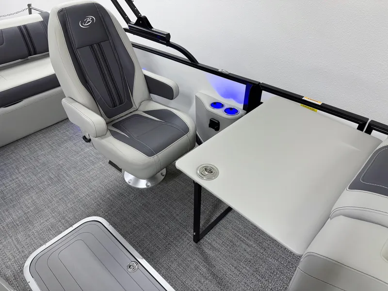 Slide: The Image of 2025 Barletta Corsa 23UC interior with gray seating, table, and cup holders. - 22