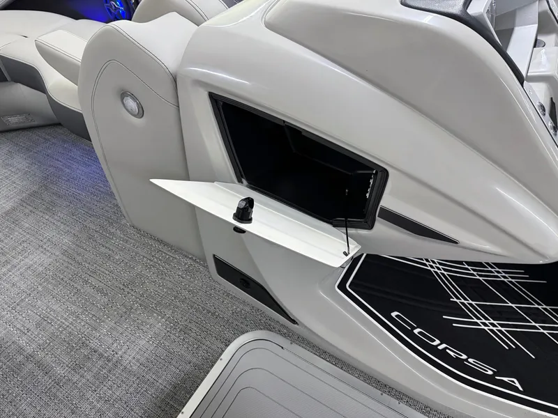 Slide: The Image of 2025 Barletta Corsa 23UC boat interior with open storage compartment and sleek design. - 25
