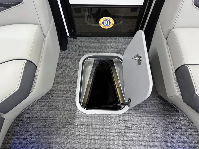 Slide: The Image of 2025 Barletta Corsa 23UC boat interior with open storage compartment on carpeted floor. - 31