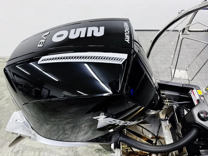 Slide: The Image of 2025 Barletta Corsa 23UC with Mercury V8 outboard engine, sleek black design. - 32