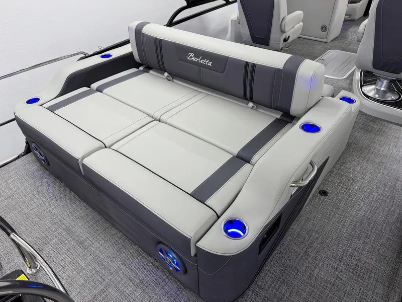 Slide: The Image of 2025 Barletta Corsa 23UC boat interior with gray seating and blue cup holders. - 4