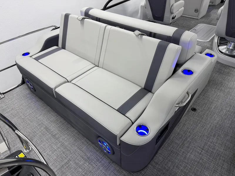 Slide: The Image of 2025 Barletta Corsa 23UC boat interior with gray seating and blue cup holders. - 5
