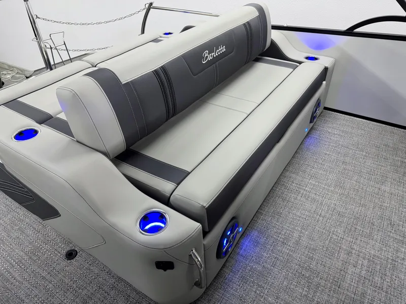 Slide: The Image of 2025 Barletta Corsa 23UC boat interior with gray seating and blue LED cup holders. - 9
